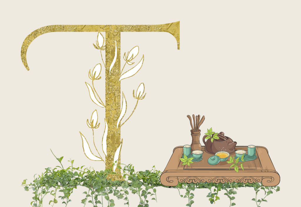 Gold letter T with vines on a floor of green leaves and vines and a wooden table with tea accessories on top 